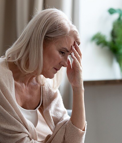 Older woman holding head in pain